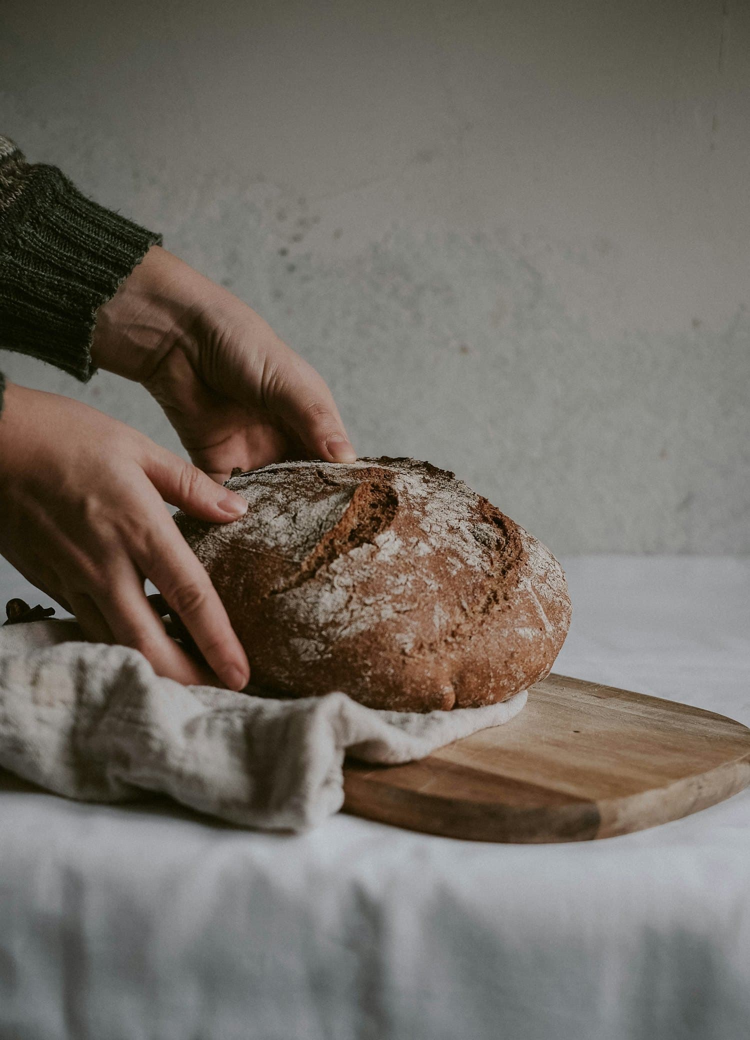 A scored round sourdough loaf with a deep golden crust, fresh from the oven